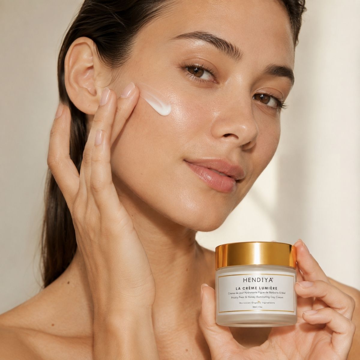 Applying La Crème Lumière to the face, Hendiya's hydrating day cream