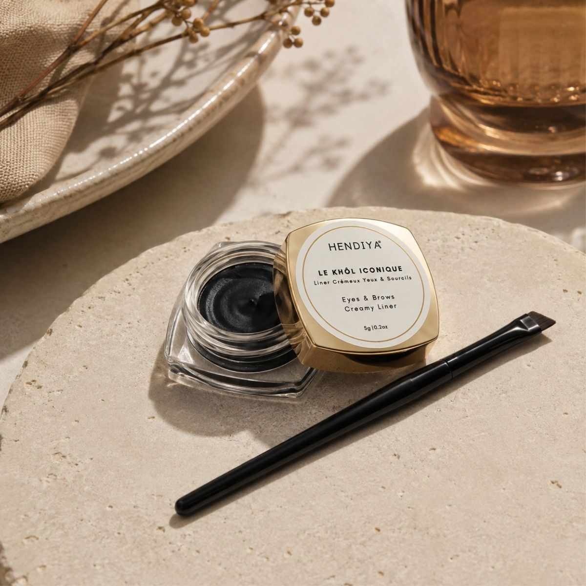 Le Khôl Iconique by Hendiya styled with its liner brush, natural organic kohl